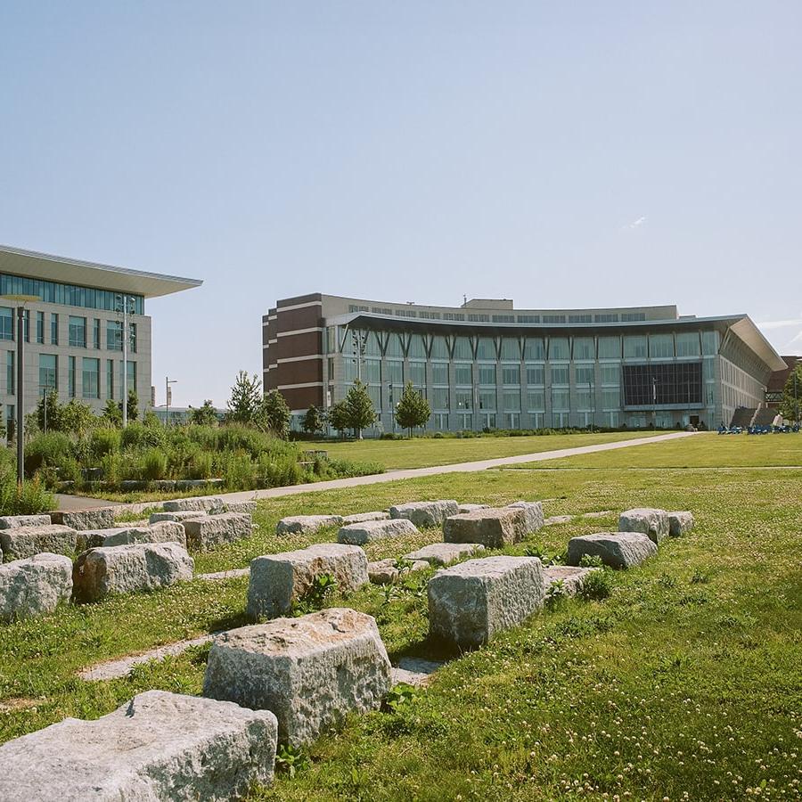 View of campus from the campus center lawn showing the stone benches.